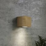 Square brass Levi wall light with downward light beam