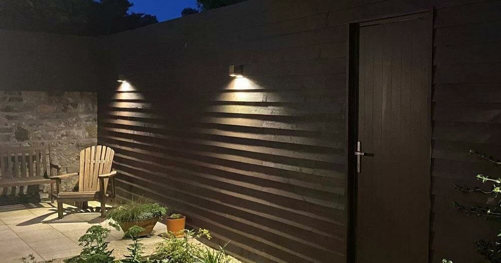 Wandlampen verlichten een terras bij een woning