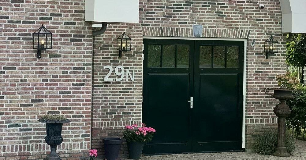 Wandlantaarns bij een garage en oprit
